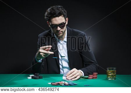 Gambling Concepts. Caucasian Young Handsome Pocker Player Staking And Betting To Win At Pocker Table