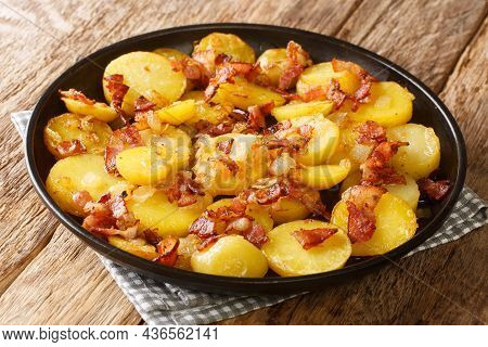 Delicious Fried Potato Bratkartoffeln With Bacon And Onion Close Up In The Plate On The Table. Horiz