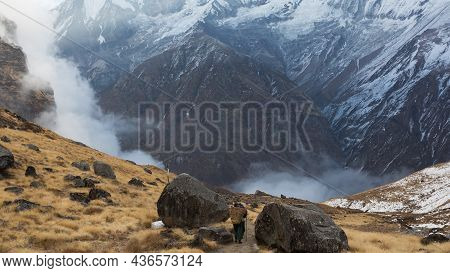 Annapurna Region, Nepal - November 10, 2018: Porters Walk The Track Abc To Machhapuchhre Base Camp, 
