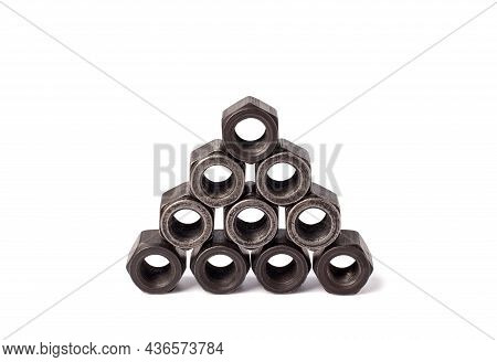 Stack Of Metallic Nuts Isolated On White Background. Heavy Hex Nut. Female Screw Nut With Copy Space