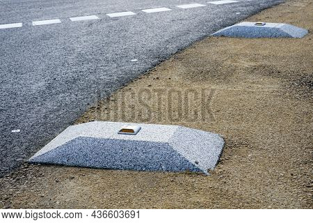 New Modern Roadside Enclosures In The Form Of A Concrete Elevation With A Yellow Reflective Road Stu