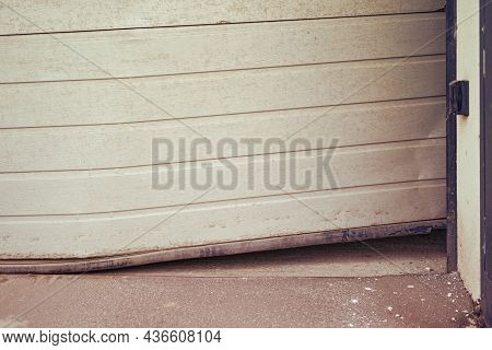 Damaged Bent Door That Rises When Opening A Lift Garage