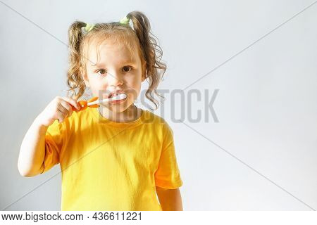 A Child, A Little Girl Brushes Her Teeth. Personal Hygiene.