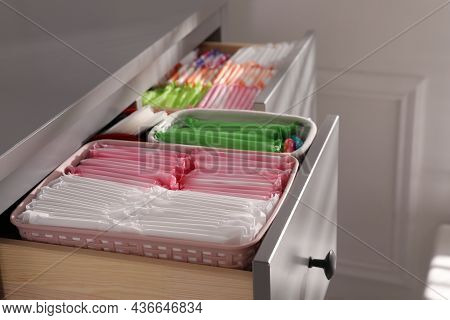 Open Cabinet Drawers With Menstrual Pads, Tampons And Pantyliners Indoors, Closeup