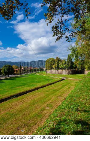 Travelling In Tuscany. The Walls Of Lucca Public Park With St Regolo Bulwark