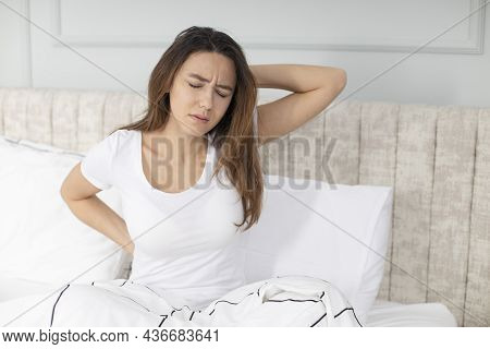 Unhappy Woman Waking Up In Uncomfortable Bed Feeling Ache In Back Pain Massaging Tensed Muscles Of S
