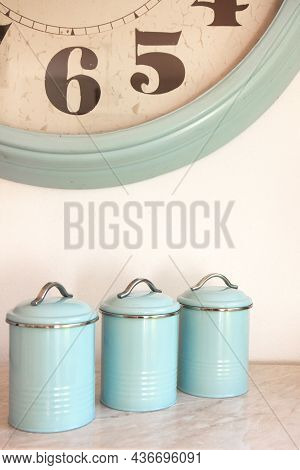 Three Blank Round Iron Kitchen Containers And Large Wall Clock On Light Background, Containers Label