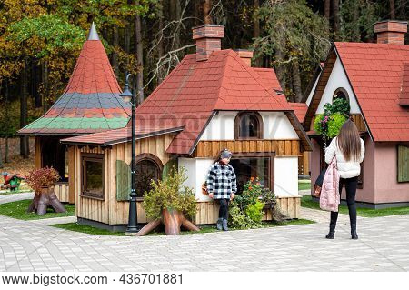 Girls Walk Around The Dwarf Village Amusement Park, Small Gnome Houses With Colorful Facade, Tervete
