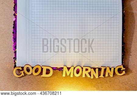 The Inscription From Wooden Letters - Good Morning, Lies On The Edge Of A Notebook In A Taphole With