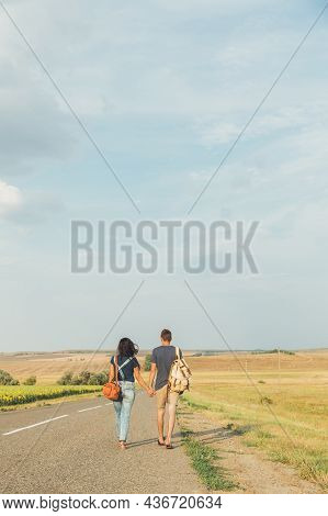Girl And Guy Are On The Road. Rear View. Concept Of Journey. Copy Space
