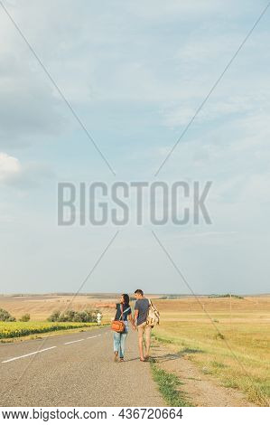 Hitchhiking. Thumb Up. Concept-adventure, Free, Freedom. Young Brunette Girl In A Denim Jumpsuit Is