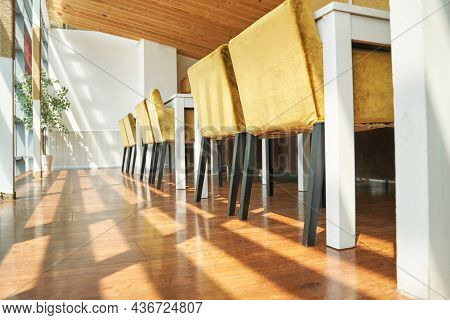 Wooden Cafe Interior. Yellow Trend Color. Bright Chair In Coffee Shop. Sum Shadows. Geometry Furnatu
