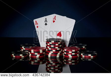 Poker Game With Three Of Kind Or Set Combination. Chips And Cards On Black Table. Successful And Win
