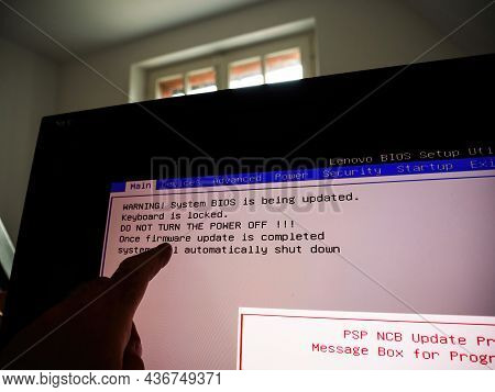 Paris, France - Apr 27, 2021: Pov Male Hand On The Touchscreen Display During Bios Update Of Lenovo 