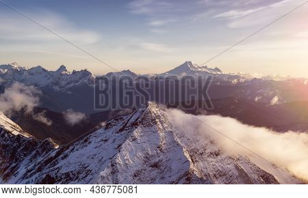 Aerial View Of Canadian Rocky Mountains With Snow On Top During Fall Season Sunset. Nature Landscape