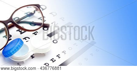Contact Lenses Case And Eye Glasses On And Eye Test Chart. Vision Concept. Way To Improve Vision. Cl