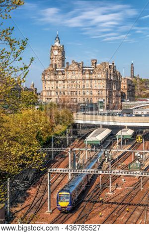 Edinburgh Waverley Railway Station With Trains Against Clock Tower Building In Scotland, United King