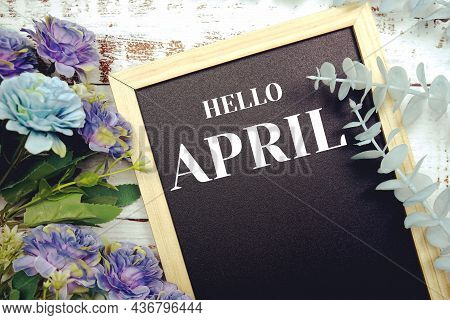 Hello April Typography Text And Flower Dcoration On Blackboard Background