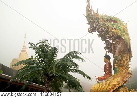 Sakon Nakhon,thailand - October 1 , 2020 : A Large Golden Seated Buddha Statue Outdoors, Sheltered B