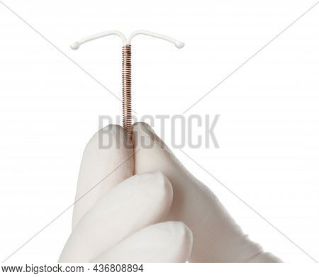 Gynecologist Holding Copper Intrauterine Contraceptive Device On White Background, Closeup