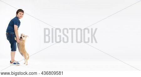 Panoramic Frame. The Dog Is Standing On His Hind Legs And The Boy Is Holding Him By His Front Paws A