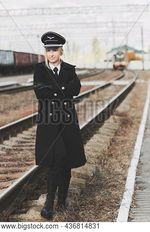 European Or American Train Conductor Is On His Duty On A Platform And Other Trains. Railway, Steam T