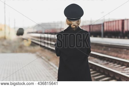 European Or American Train Conductor Is On His Duty On A Platform And Other Trains. Railway, Steam T