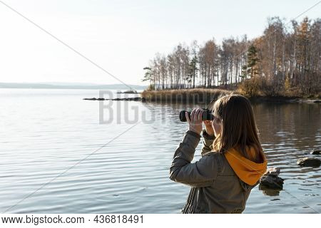 Young Woman Looking Through Binoculars At Birds On Lake Birdwatching, Zoology, Ecology. Research In 