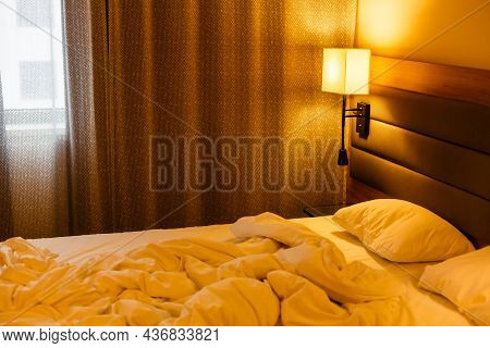 White Bed Made-up With Wrinkled Bed Sheets After Sexual Night. White Bedding Sheets After Wake Up In