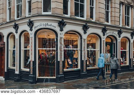London, Uk - October 02, 2021: People In Raincoats Walk Past Harvie And Hudson, A Mens Shop Selling 