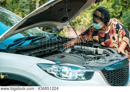 An Old Woman Standing At A Broken Car Trying To Fix The Car Senior Woman The Car Is Broken Road And 