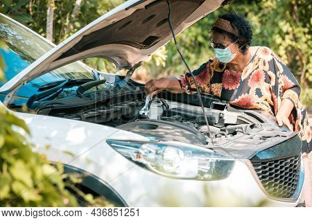An Old Woman Standing At A Broken Car Trying To Fix The Car Senior Woman The Car Is Broken Road And 