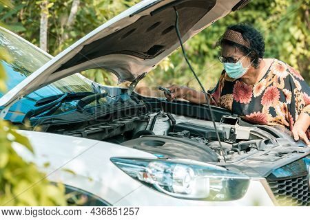 An Old Woman Standing At A Broken Car Trying To Fix The Car Senior Woman The Car Is Broken Road And 