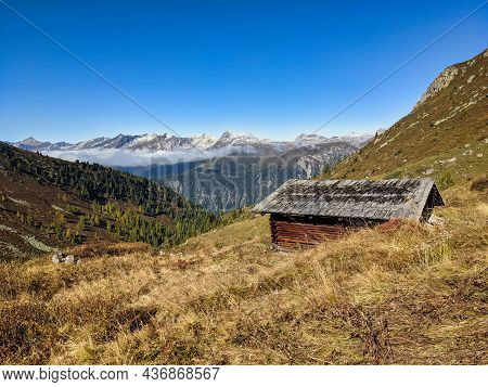 Old Farmers Head On The Alp Meadow Above Monstein Davos. Beautiful Hiking Landscape In Switzerland. 