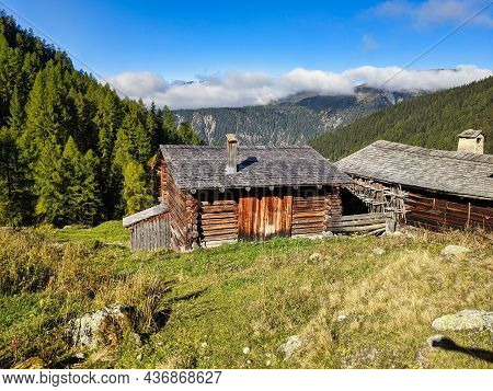 Old Farmers Head On The Alp Meadow Above Monstein Davos. Beautiful Hiking Landscape In Switzerland. 