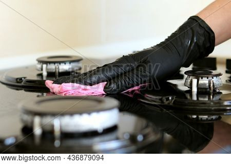 Girl In Black Disposable Gloves Washes The Hob, Glass Surface