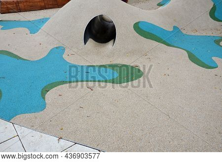 Dreamy White Rubber Landscape With Scoops And Colorful Spots On The Playground. Stainless Steel Tunn