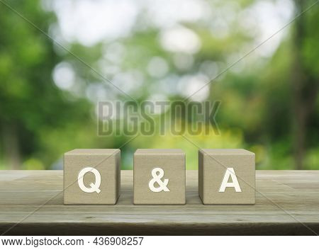 Q And A Acronym On Wood Block Cubes On Wooden Table Over Blur Green Tree In Park, Frequently Asked Q