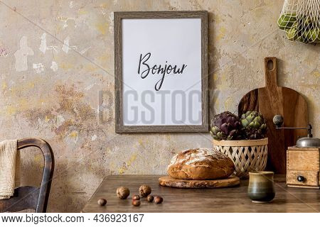 Stylish Interior Of Kitchen Space With Wooden Table, Brown Mock Up Photo Frame, Herbs, Vegetables, T
