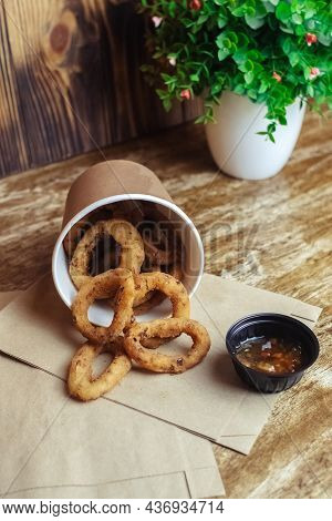 Close-up Of Onion Rings In Batter. Fried Vegetables At A Fast Food Restaurant. Vegetarian Cuisine In