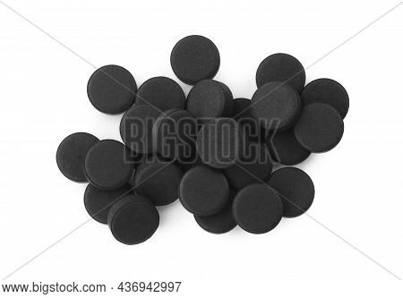 Activated Charcoal Pills On White Background, Top View. Potent Sorbent