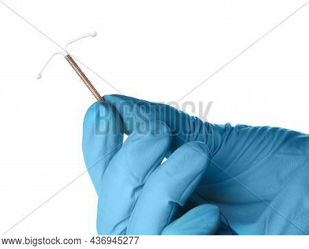 Gynecologist Holding Copper Intrauterine Contraceptive Device On White Background, Closeup