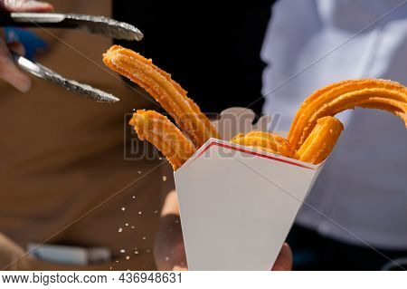 Homemade Crunchy Churros In White Paper Box At Summer Outdoor Food Market - Close Up. Traditional Sp