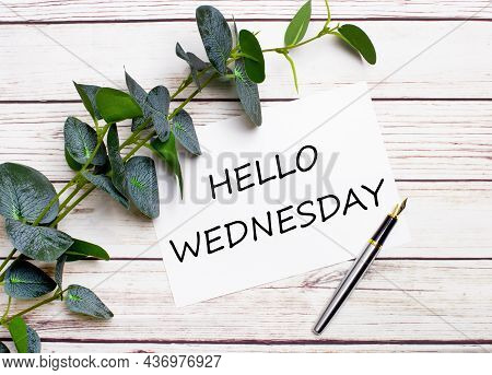 On A Light Wooden Table, There Is A Eucalyptus Branch, A Fountain Pen And A Sheet Of Paper With The 