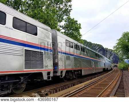 Harpers Ferry, Virginia, U.s.a - June 19, 2021- An Amtrak Train Stopped By The Railway Station
