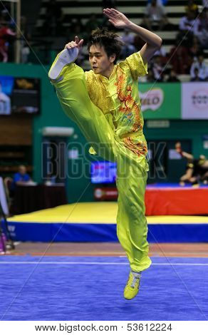 KUALA LUMPUR - NOV 03: Yeap Wai Kin of Malaysia shows a wushu high kick in the 'changquan compulsory' event at the 12th World Wushu Championship on November 03, 2013 in Kuala Lumpur, Malaysia.