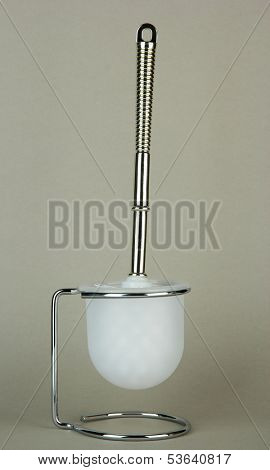 Toilet brush on grey background