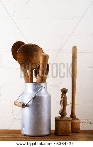 retro kitchen utensils tools on old wooden table in rustic style