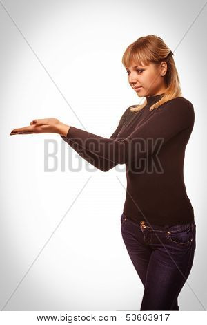 portrait happy young blond woman showing open hand holding black