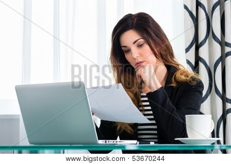 Businesswoman working in business hotel, maybe she working on a contract or using wifi for the computer